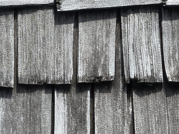 Close-up of gray, worn cedar shake edges